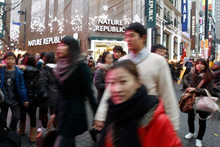 People walking in a crowded street in South Korea.