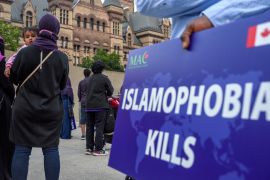 Someone holds a sign reading, 'Islamophobia Kills' during a rally in Toronto, Canada against Islamophobia
