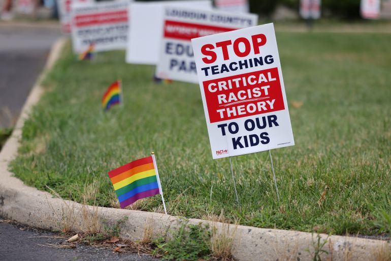 Signs opposing Critical Race Theory line the entrance to the Loudoun County School Board headquarters, in Ashburn, Virginia, U.S. June 22, 2021. REUTERS/Evelyn Hockstein