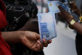 A person holds a new 1000 Naira note as the Central Bank of Nigeria releases the notes to the public through the banks in Abuja, Nigeria