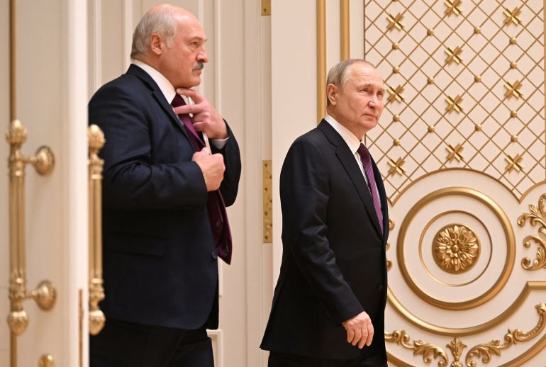 Russian President Vladimir Putin and Belarusian President Alexander Lukashenko arrive for a news conference following their meeting in Minsk, Belarus.
