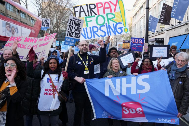NHS nurses hold signs during a strike, amid a dispute with the government over pay, in London, Britain December 20, 2022.