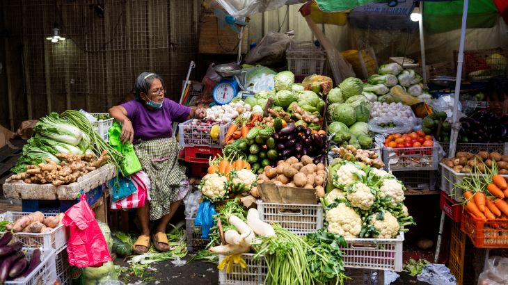 A vegetable vendor tends to her store at a public market, ahead of New Year celebration, in Manila, Philippines, December 30, 2022