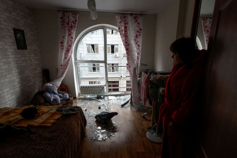 Kyiv resident Kateryna stands inside a room of her apartment damaged by a Russian drone on December 30, 2022.