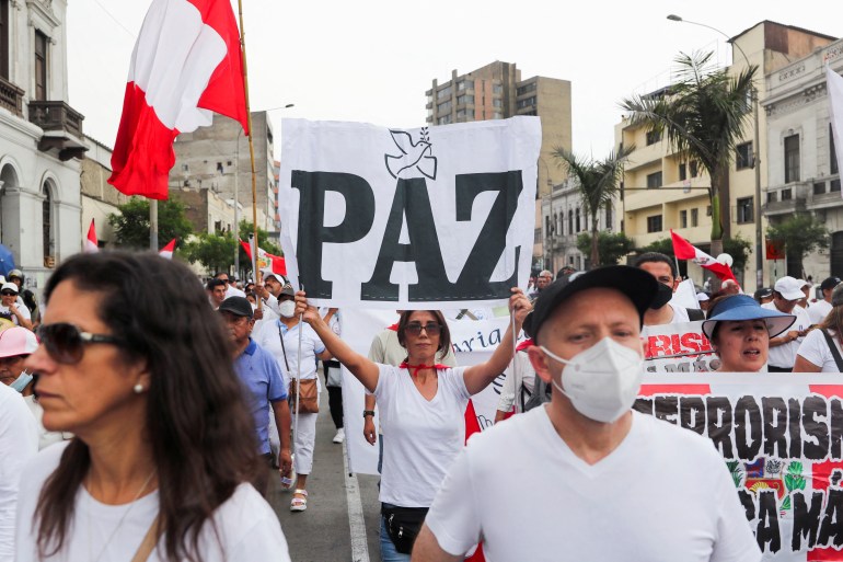 People march at a rally for peace in Lima, Peru