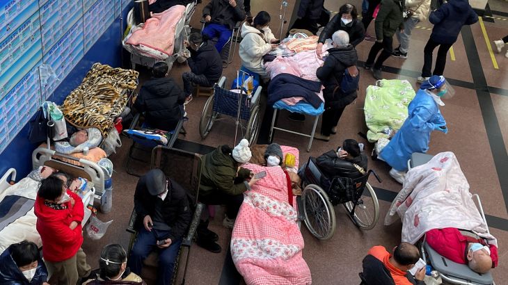 Patients lie on beds and stretchers in a hallway in the emergency department of a hospital, amid the coronavirus disease (COVID-19) outbreak in Shanghai, China January 4, 2023. REUTERS/Staff TPX IMAGES OF THE DAY