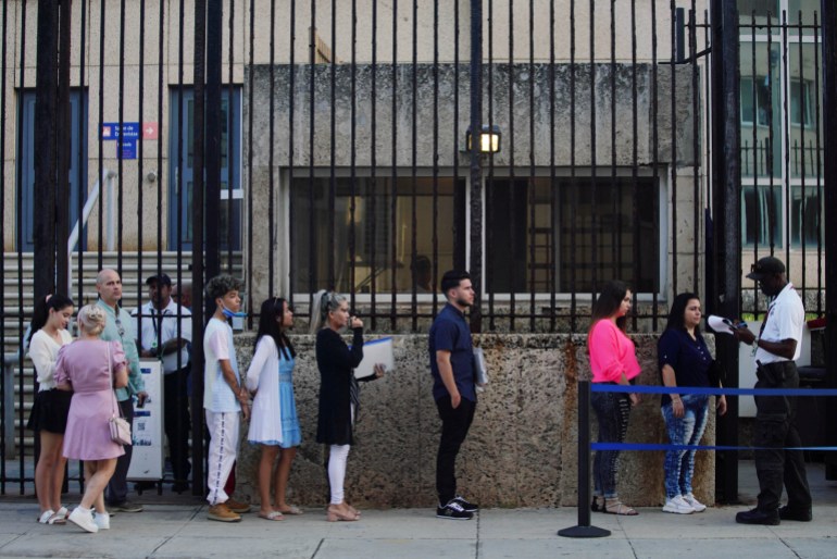 People line up in front of the US Embassy in Havana, Cuba