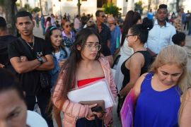 People wait to enter the US embassy in Havana, Cuba