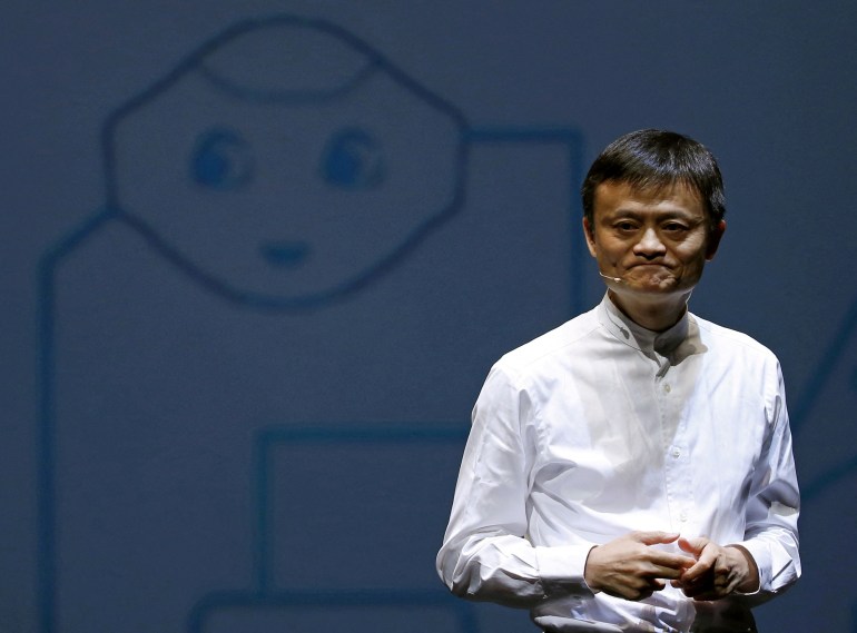 FILE PHOTO: Jack Ma, founder and executive chairman of China's Alibaba Group, speaks in front of a picture of SoftBank's human-like robot named 'pepper' during a news conference in Chiba, Japan, June 18, 2015. REUTERS/Yuya Shino/File Photo