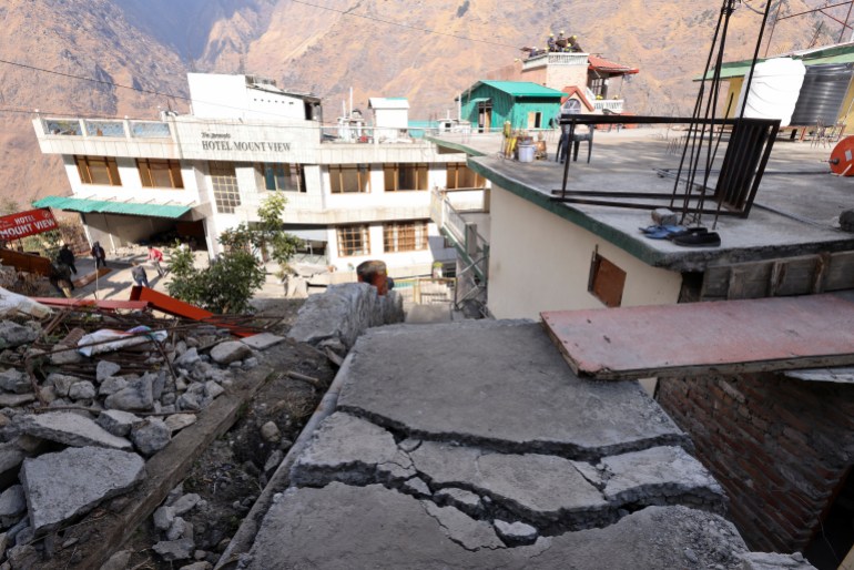 Cracks are seen on the ground outside of a residential house as State and National Disaster Response forces demolish a hotel after cracks developed on the property, in Joshimath, in the northern state of Uttarakhand, India, January 13, 2023. REUTERS/Anushree Fadnavis
