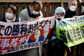 Supporters of plaintiffs hold banners after the the Tokyo High Court upheld a not guilty verdict for former Tokyo Electric Power Company executives over the 2011 Fukushima nuclear power station disaster, in Tokyo, Japan, on January 18, 2023
