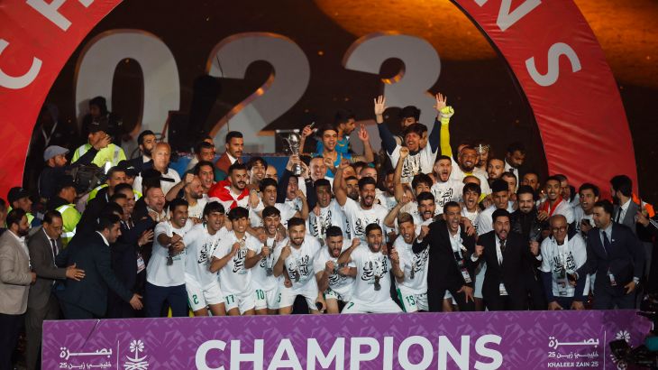 Iraq players celebrate with the trophy after defeating Oman 3-2 in Arabian Gulf Cup