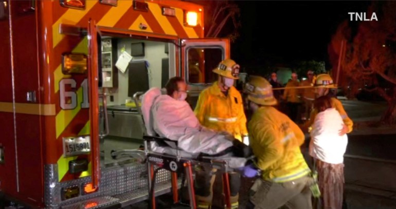 A screenshot from a video shows emergency workers helping a man to an ambulance after a shooting in Monterey Park, California, U.S., January 22, 2023.