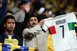 A fan of Saudi football club Al Nassr holds a Portugal shirt with Cristiano Ronaldo&#39;s name printed on the back[Ahmed Yosri/Reuters]
