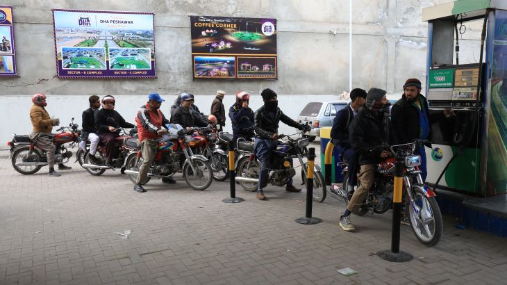 People wait for their turn to get fuel at a petrol station, a day after a country-wide power breakdown, in Peshawar, Pakistan, January 24, 2023.