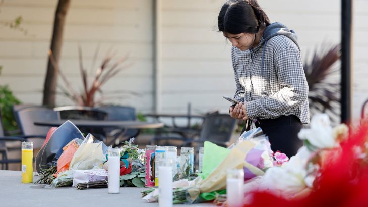 Half Moon Bay resident Susana Gutierrez visits a memorial for shooting victims at Mac Dutra Park in Half Moon Bay, California.