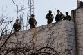 Israeli forces take up position during confrontations with Palestinians, in Hebron, in the Israeli-occupied West Bank