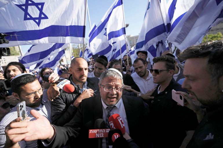 Israeli lawmaker Itamar Ben-Gvir, center, surrounded by right wing activists with Israeli flags, speaks to the media as they gather for a march in Jerusalem, Wednesday, April 20, 2022. Major Jewish American organizations, traditionally a bedrock of support for Israel, have expressed alarm over the presumptive government's far-right character. Given American Jews' predominantly liberal political views and affinity for the Democratic Party, these misgivings could have a ripple effect in Washington and further deepen what has become a partisan divide over support for Israel. (AP Photo/Ariel Schalit, File)