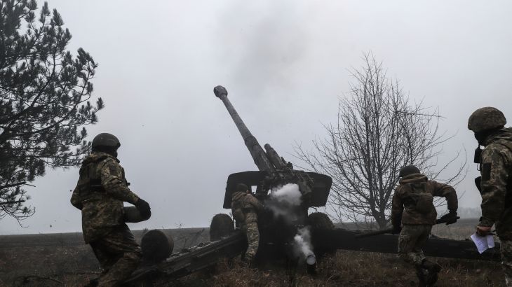 A Ukrainian serviceman fires towards Russian positions