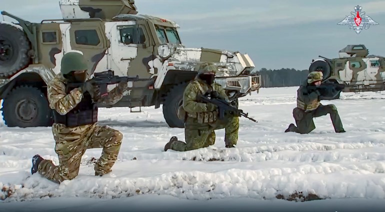 In this handout photo taken from video released by the Russian defense ministry on December 28, Russian troops take part in drills at an unspecified location in Belarus