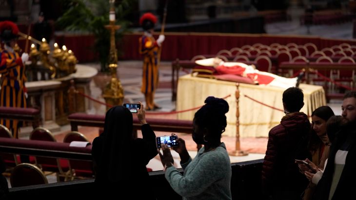 People look at the body of late Pope Emeritus Benedict XVI laid out in state inside St. Peter's Basilica at The Vatican