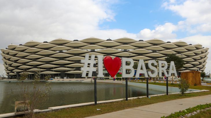 Large white letters and a red heart shape spell out 'I love Basra' in front of a newly built stadium that will host the Arabian Gulf Cup in Basra, Iraq.