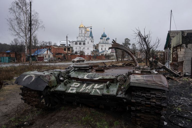 A destroyed Russian tank stands across the road of a church in the town of Sviatohirsk, Ukraine, Friday, Jan. 6, 2023.