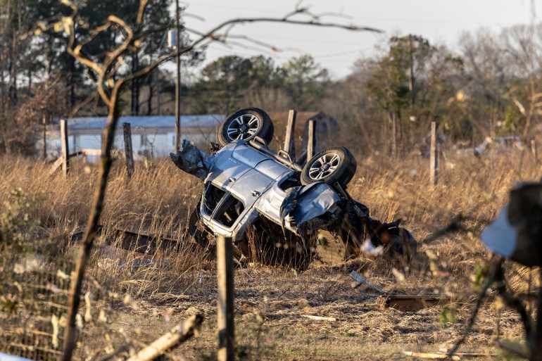 An overturned SUV near a county road