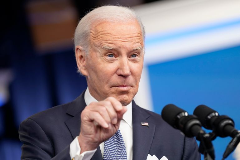 Joe Biden points a finger in a press conference.