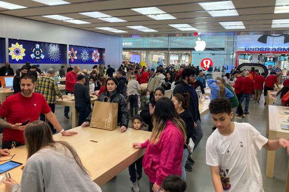 People shop at an Apple store in the Westfield Garden State Plaza mall in Paramus, New Jersey