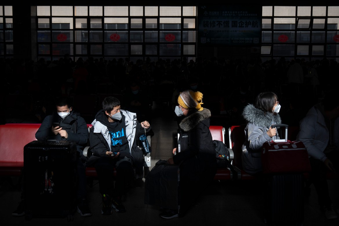 Travelers sit in a waiting room at Beijing West Railway Station in Beijing