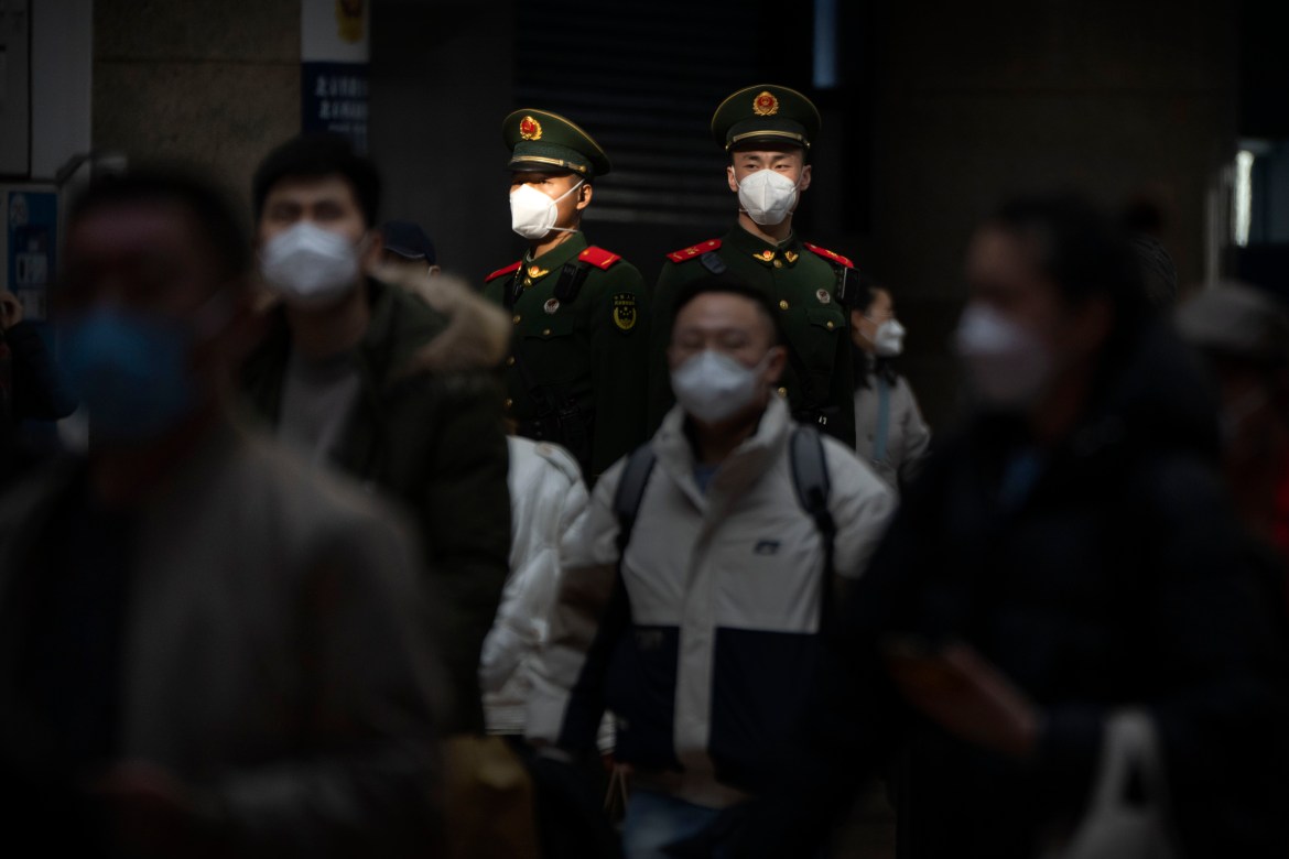 Chinese paramilitary police stand guard at Beijing West Railway Station in Beijing