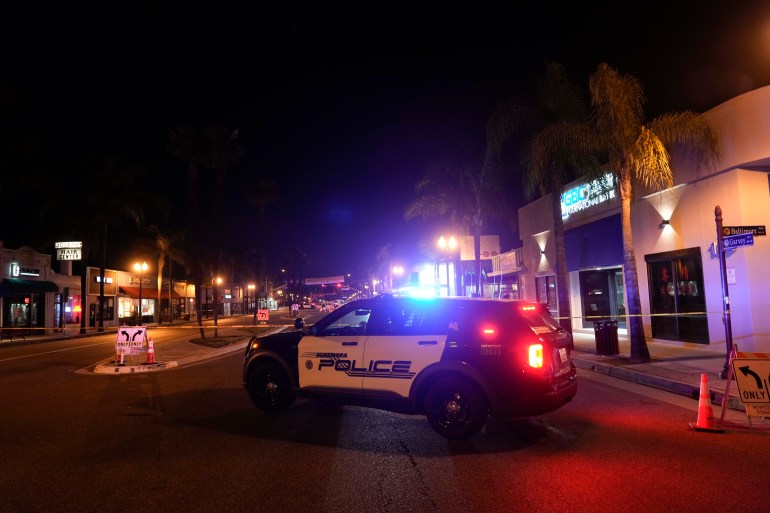 A police vehicle is seen near a scene where a shooting took place in Monterey Park, Calif., Sunday, Jan. 22, 2023. Dozens of police officers responded to reports of a shooting that occurred after a large Lunar New Year celebration had ended in a community east of Los Angeles late Saturday.