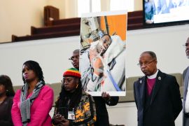 Family members and supporters hold a photograph of Tyre Nichols at a July 23 news conference in Memphis, Tennessee, the United States [Gerald Herbert/AP Photo]