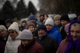 Residents of Kalynivske line up for the aid they need to survive not far from one of Ukraine&#39;s front lines. [Daniel Cole/AP]