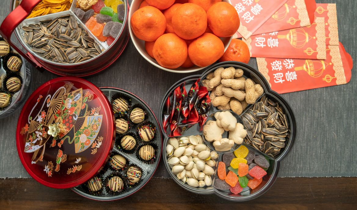 Overhead shot of a table laden with sweets and snacks for Chinese New Year