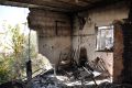 The destroyed home where three known Palestinian fighters were taking shelter when Israel attacked it with surface-to-air missiles, causing it also to set on fire.