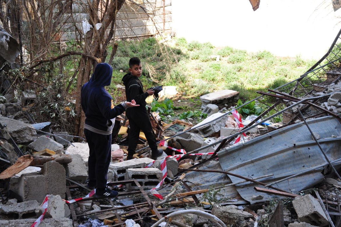 Palestinian children inspect the destruction that was left behind on the home.