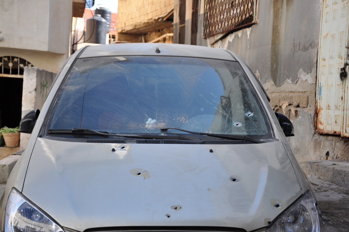 Bullet holes and shattered glass can be seen on almost every car in Jenin neighbourhood.