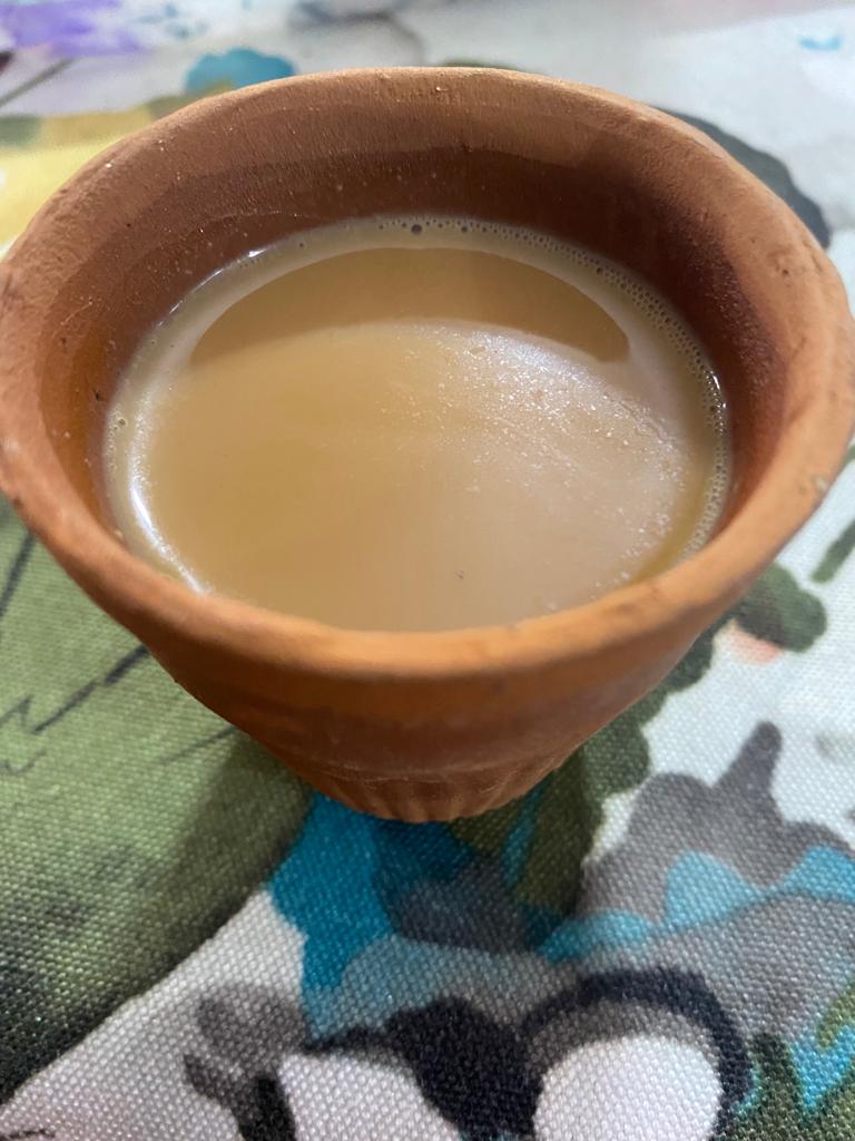 A clay cup of chai on a patterned background