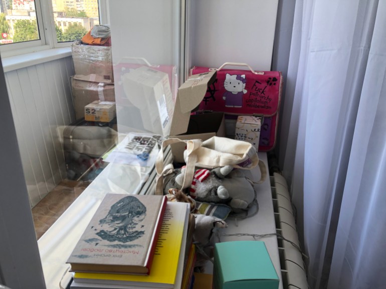 A photo of various items including a bag, books and plush toys.