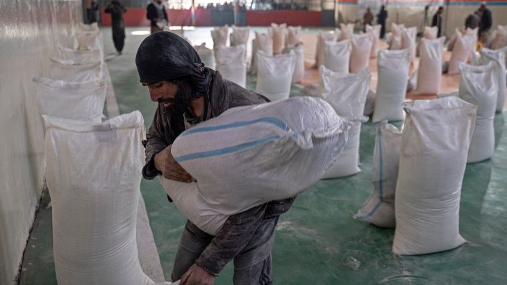 A man arranges food aid bags at a gymnasium in Kabul.
