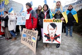 Protesters gather in support of Ukraine during a meeting of European Union Foreign Ministers in Brussels, Belgium.