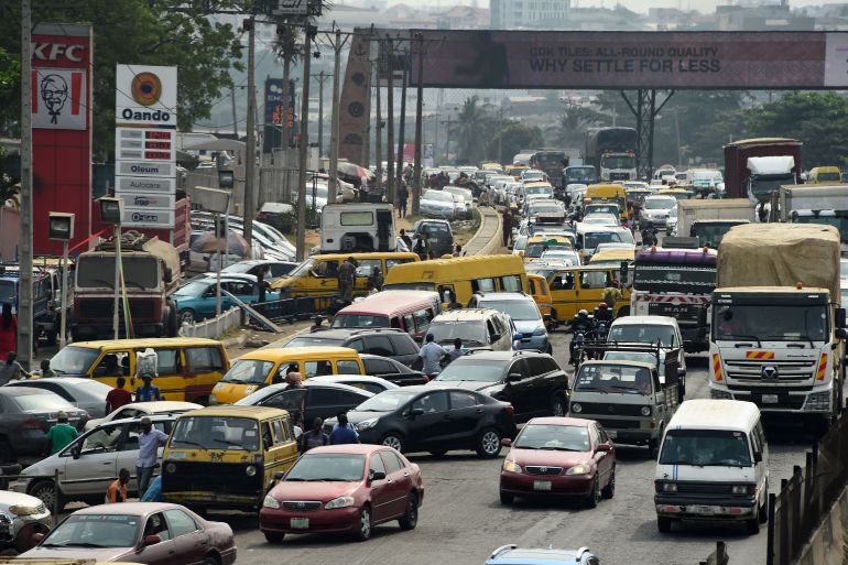 Drivers wait in line to buy fuel at and next to a filling station, causing traffic gridlock on Lagos' Ibadan expressway, in Lagos