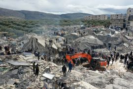 Residents search for victims and survivors in the rubble of collapsed buildings in Besnia, Syria, near the border with Turkey [Omar Haj Kadour/AFP]