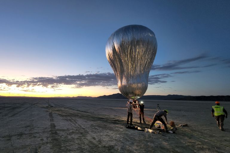 A prototype aerial robotic balloon, or aerobot, is readied for a sunrise test flight at Black Rock Desert, Nevada