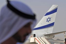 An Emirati official stands near an air-plane of El Al.
