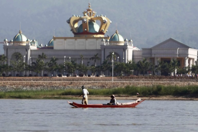People manoeuvre a small boat along the Mekong river in front of the Kings Roman casino opposite Sop Ruak in the Golden Triangle region where the borders of Thailand, Laos and Myanmar meet January 15, 2012. The murder of 13 Chinese sailors last October on the Mekong was the deadliest attack on Chinese nationals overseas in modern times and highlights the growing presence of China in the Golden Triangle, the opium-growing region straddling Myanmar, Laos and Thailand. Picture taken January 15, 2012. To match Special Report MEKONG-CHINA/MURDERS REUTERS/Sukree Sukplang (THAILAND - Tags: CIVIL UNREST MARITIME TRAVEL BUSINESS POLITICS)