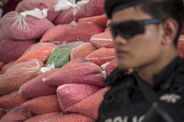 A police officer from the Narcotics Control Board guards bags of methamphetamine pills during a Destruction of Confiscated Narcotics ceremony in Ayutthaya province, north of Bangkok, Thailand, June 26, 2015. About 7,340 kg (16,182 lbs) of drugs, among them methamphetamine, marijuana, heroin and opium worth more than 22 billion baht ($651,000,000), were destroyed during the anti-drug campaign, according to the Public Health Ministry. REUTERS/Athit Perawongmetha