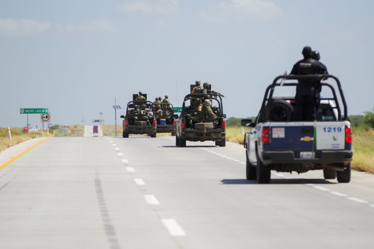 Security forces patrol a highway near Nuevo Laredo, Mexico, looking for missing people.